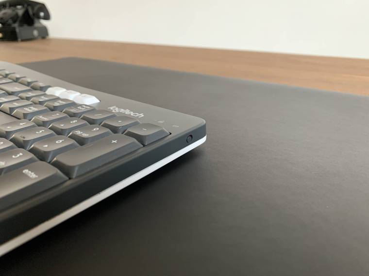 Donker eiken bureaublad en Logitech toetsenbord te Breda